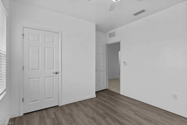 Unfurnished bedroom with ceiling fan and light hardwood / wood-style floors