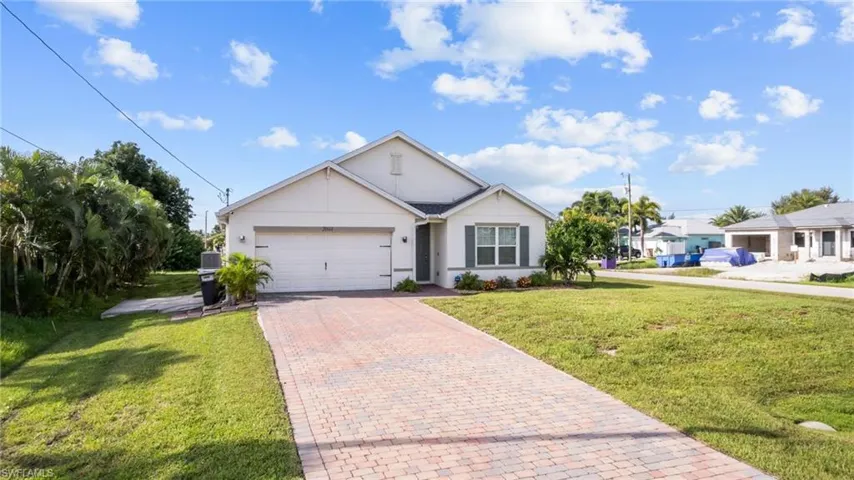 View of front facade with a garage and a front lawn