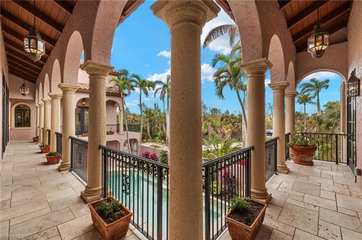 Balcony featuring view of pool area