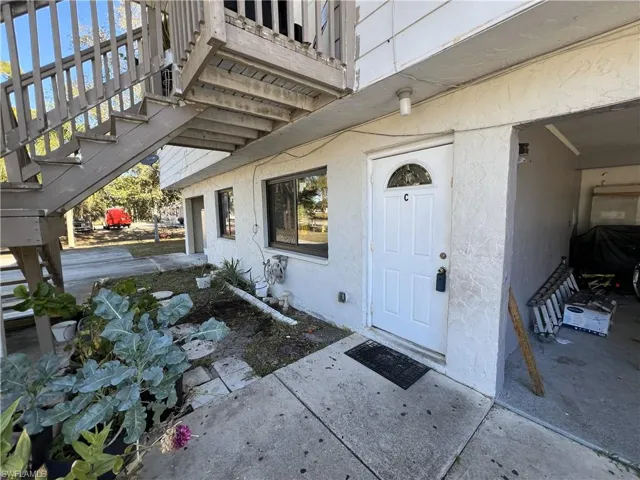 View of exterior entry with stucco siding