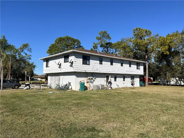 Rear view of house with a lawn