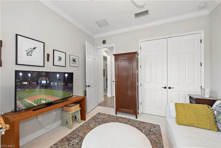 Carpeted 3rd Bedroom used as a sitting room/art studio with lots of light!