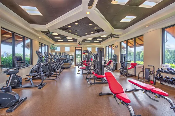 Workout area with crown molding, healthy amount of natural light, and coffered ceiling
