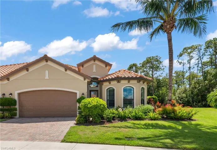 Mediterranean / spanish-style home with stucco siding, decorative driveway, a front lawn, a tile roof, and an attached 2 car garage