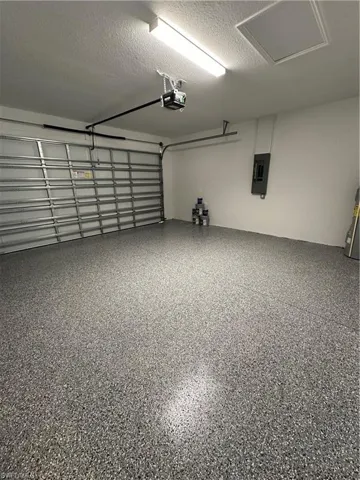 Garage with electric panel and a garage door opener