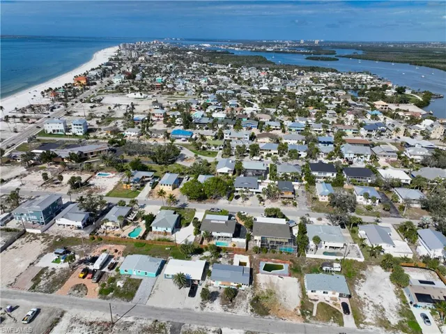Drone / aerial view with a water view and a beach view