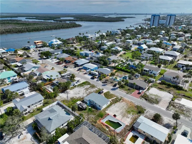 Birds eye view of property with a water view