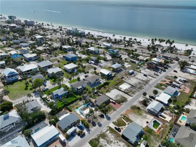 Birds eye view of property with a water view