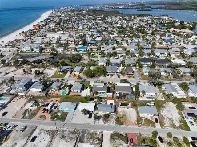 Birds eye view of property featuring a beach view and a water view