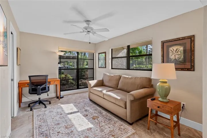 Tiled office with ceiling fan and a wealth of natural light