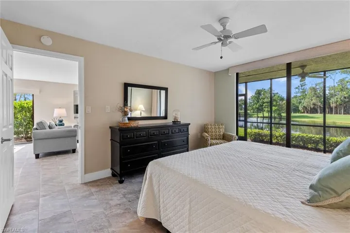 Bedroom with access to outside, light tile patterned floors, and ceiling fan