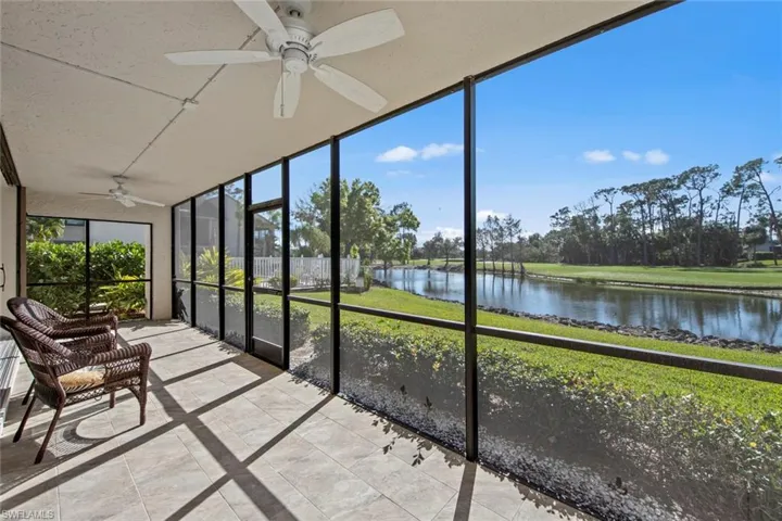 Sunroom / solarium with a water view and ceiling fan