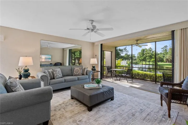 Living room featuring a water view and ceiling fan