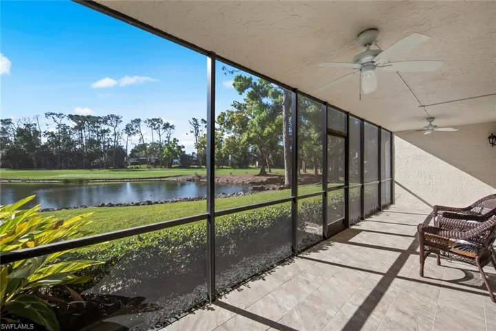 Unfurnished sunroom featuring ceiling fan and a water view