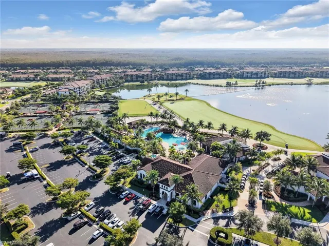 Aerial View of the Front of the Clubhouse, Pools, Golf Course, and Lake