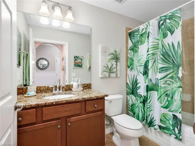 Second Bathroom with Granite Counter, Tile Flooring, & Tiled Tub/Shower Combo