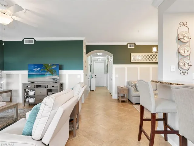 Living Room with Board & Batten Wall Treatment, Crown Molding, Breakfast Bar, & Nook/Dining Area with Board & Batten Wall Treatment