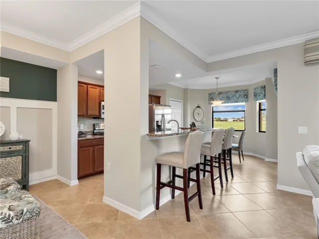 Nook/Dining Area, Kitchen with Breakfast Bar Leading Into Eat In Kitchen with Bay Window & Window Treatments