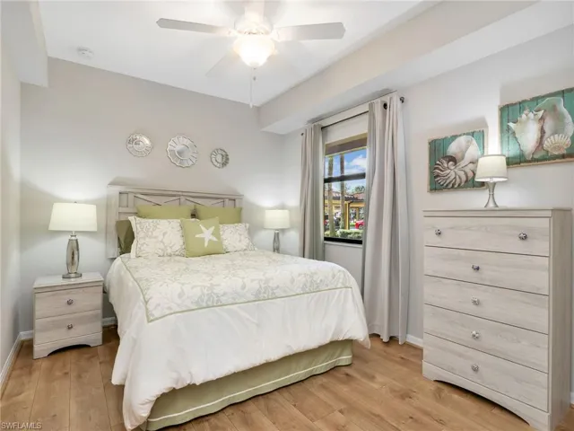 Second Bedroom with Laminate Flooring, Ceiling Fan, and Window Treatment