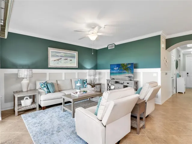 Living Room with Board & Batten Wall Treatment, Crown Molding, & Ceiling Fan