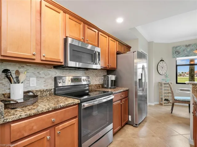 Kitchen with Stainless Steel Appliances, Stainless Steel Sink, Granite Counters, Tile Backsplash, & Eat In Kitchen with Bay Window & Window Treatments