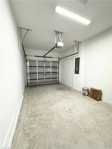 Garage with a garage door opener and electric panel