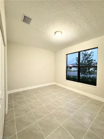 Empty room featuring a textured ceiling