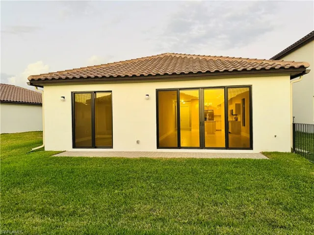 Back of property with a yard