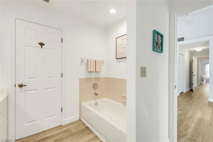 Guest bathroom features a tub.