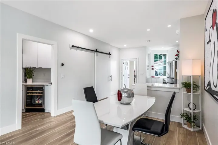 View of the kitchen and wine/beverage refrigerator in your utility room!
