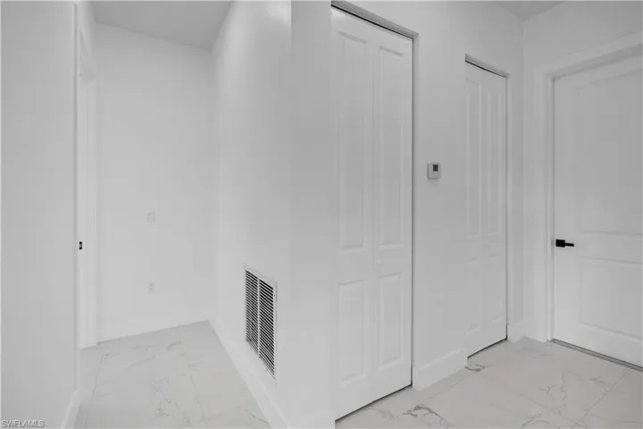 Hall with light marble finish flooring