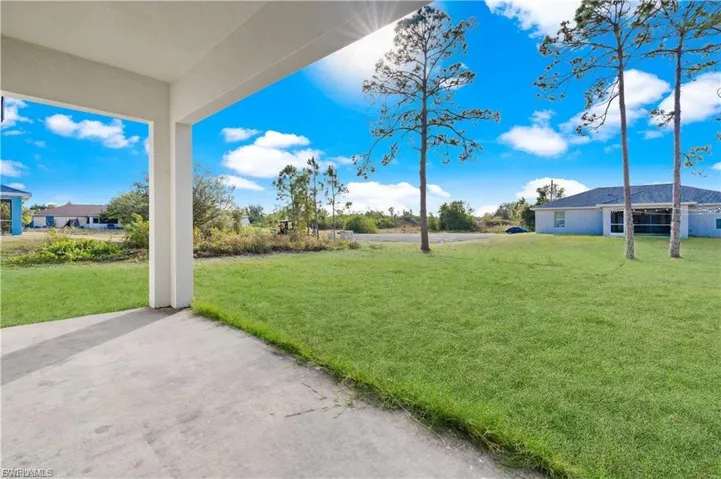 View of grassy yard with a patio