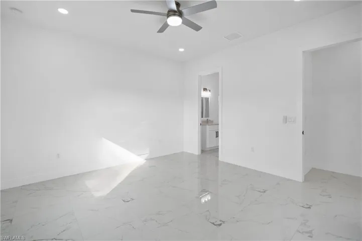 Spare room featuring light marble finish flooring, recessed lighting, and ceiling fan
