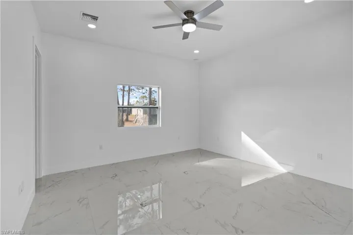 Empty room with light marble finish flooring, recessed lighting, and a ceiling fan