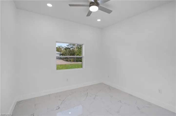 Unfurnished room with light marble finish floors, recessed lighting, and a ceiling fan