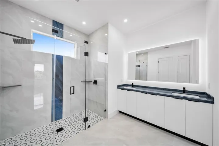 Bathroom featuring walk in shower and vanity