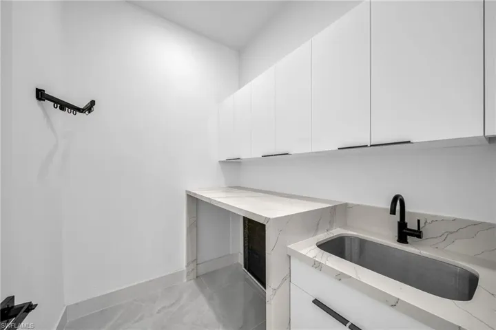 Clothes washing area featuring sink