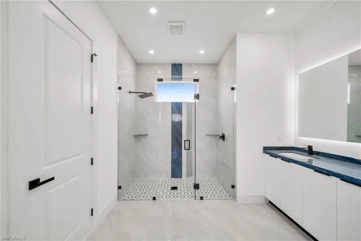 Bathroom featuring walk in shower and vanity