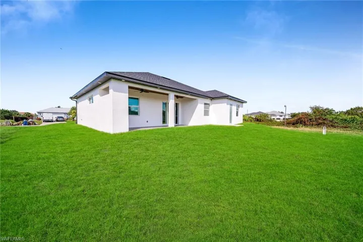 Rear view of house with a yard
