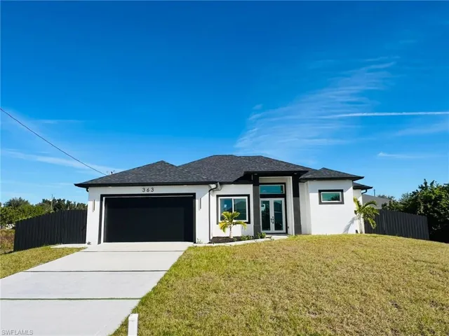 Prairie-style house featuring french doors, a garage, and a front lawn