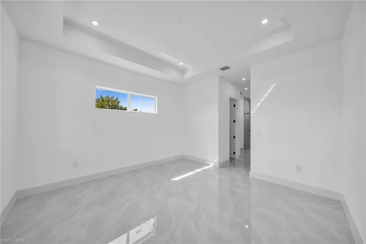 Unfurnished room with a tray ceiling