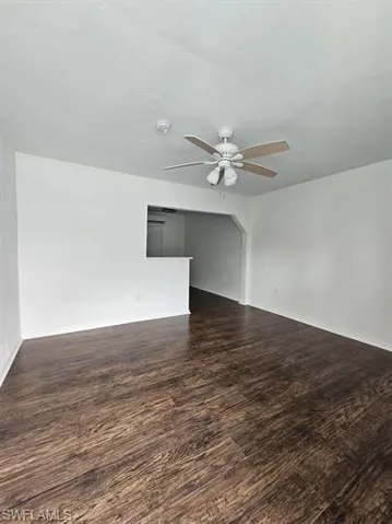 Spare room with dark wood-style floors and ceiling fan