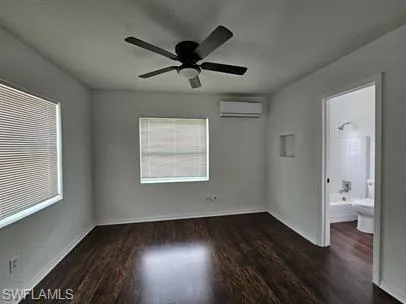 Unfurnished bedroom with dark wood-style flooring and a ceiling fan