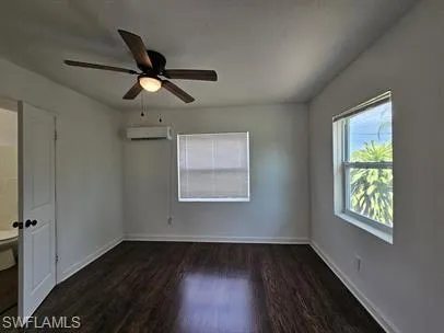 Unfurnished bedroom with dark wood-style flooring and ceiling fan