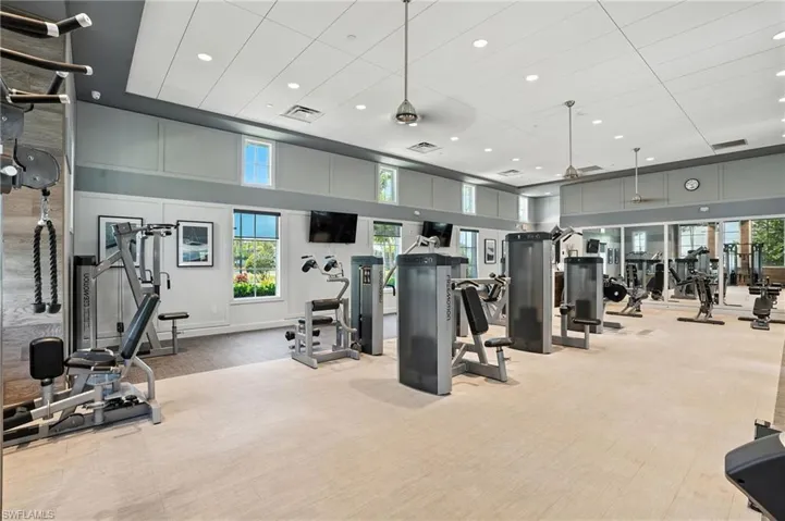 Gym featuring carpet, a high ceiling, and recessed lighting