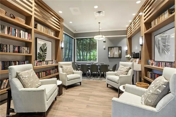 Living area with crown molding, light wood-type flooring, recessed lighting, and built in features