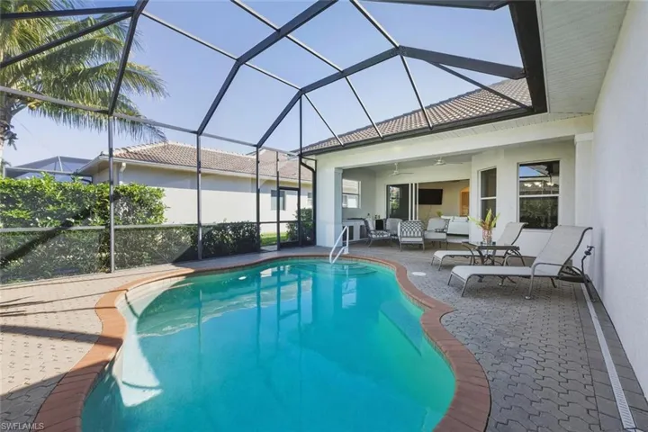 Outdoor pool with a sunroom, a lanai, a patio area, and outdoor lounge area