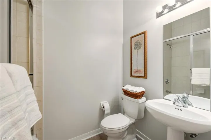 Bathroom with toilet and a tile shower