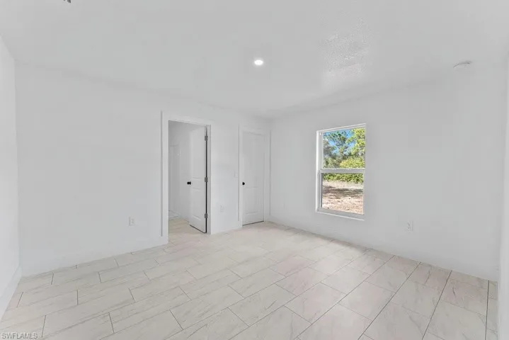 Spare room featuring baseboards and recessed lighting