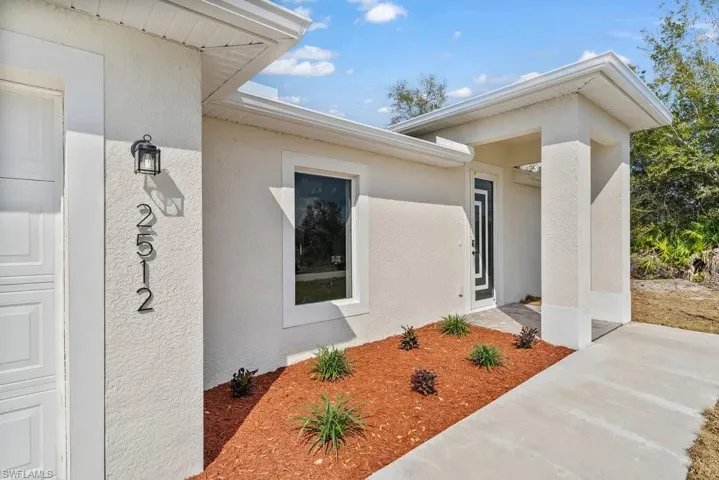 View of exterior entry with stucco siding